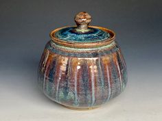 a brown and blue pot with a lid