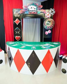 a casino booth with red, black and white checkered flooring on the sides