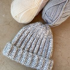 three balls of yarn sitting next to each other