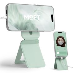 an iphone is connected to a charging station with a face on the phone holder, and it's plugged in