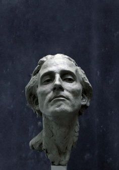 a statue of a man's head with his eyes closed