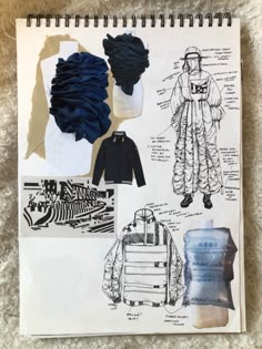 an open notebook with drawings and clothes on it