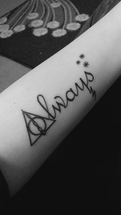 a harry potter tattoo with the word always written on it's arm and hogwarts