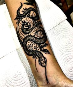 a woman's arm with a tattoo on it and an image of a snake