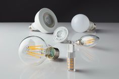 several different types of light bulbs on a white surface with one bulb turned upside down