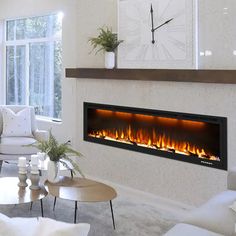 a living room filled with furniture and a fire place next to a clock on the wall