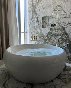 a large bath tub sitting next to a window