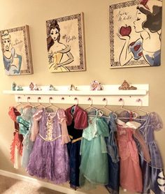 there are many princess dresses hanging on the wall