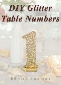 a table with flowers and candles on it that says diy glitter table numbers 1