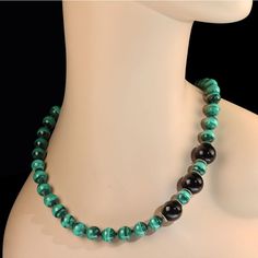 This is part of Chairish’s Costume Jewelry assortment.  Immerse yourself in timeless elegance with this magnificent 20-inch Malachite necklace, a true statement of luxury and sophistication. The necklace features 10mm smooth Malachite beads, renowned for their vivid green hues and signature banded patterns, expertly separated by sparkling faceted black Spinel accents that add a dazzling touch. Highlighting the design are three striking 15mm smooth black Onyx beads, positioned as bold focal point 20 Inch Necklace, Malachite Necklace, Princess Necklace, Malachite Jewelry, Hammered Sterling Silver, Black Spinel, Onyx Bead, Black Onyx, Costume Jewelry