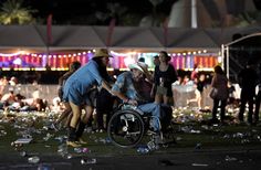 a man in a wheel chair is surrounded by people at an outdoor event with confetti all over the ground