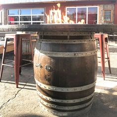 a large wooden barrel sitting in front of a building