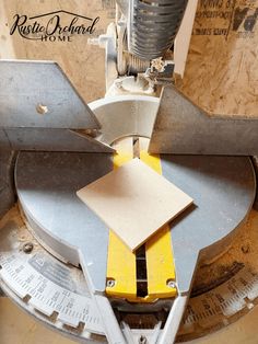 a machine that is cutting some paper on top of it's bladed end