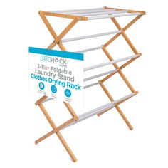 two wooden clothes drying racks with signs attached to the top and bottom, standing upright against a white background