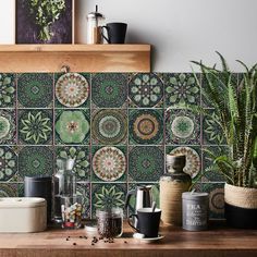 a kitchen counter topped with lots of potted plants and pots on top of it