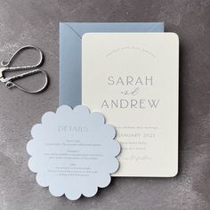 the wedding stationery is laid out on top of the table next to scissors and a pair of shears