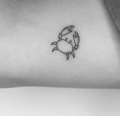 a small crab tattoo on the left side of the neck and arm, with a black outline