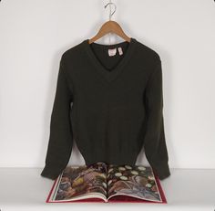 Dark olive green v-neck vintage pullover wool sweater. Rib knit cuffs and hem, 1980's era, one dropped stitch on left chest but otherwise in good shape! 44" max chest, 40" max hem, 23" long.  **Please- We highly encourage all questions about the items listed.** If the size, color, condition of the item is unclear or you have questions regarding shipping please message us before completing your order. If you need assistance understanding your measurements please contact us and we will do our best to guide you so that you and your item are a perfect fit!  We are two women of Portland, Oregon, who love clothing and the power of adornment. Clothing is as old as culture itself and is cross-species. We believe that adornment is a physical expression of self so we put this shop together to help c Vintage Pullover, Vintage Pullovers, Dark Olive Green, Love Clothing, Knit Pullover, Knit Cuff, Portland Oregon, Wool Sweater, Knitted Pullover