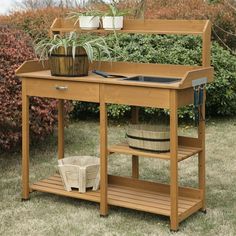 a potted plant sitting on top of a wooden table next to a garden bench