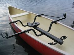 a red and white boat sitting in the water