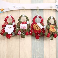 christmas ornaments hanging on a wall with snowflakes and santa clause decorations around them