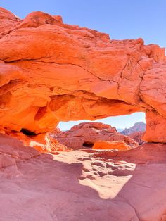 an orange rock formation with a blue sky in the background