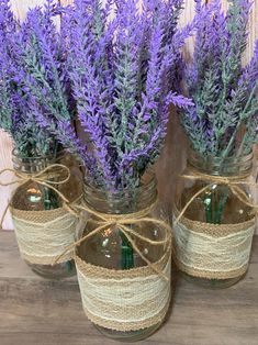 three mason jars filled with lavender flowers tied in twine