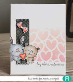 a close up of a card with an animal and heart on the front, and two hearts in the back