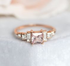 an engagement ring with three princess cut diamonds