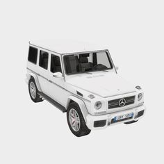 a white mercedes g - class suv is shown from the side