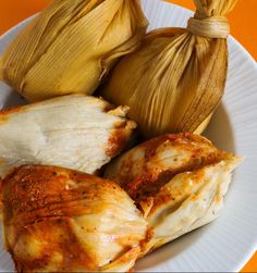 some food is on a white plate with orange background