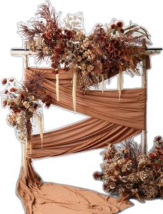 an arrangement of dried flowers and foliage on display