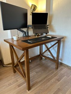 a computer desk with a laptop and monitor on it