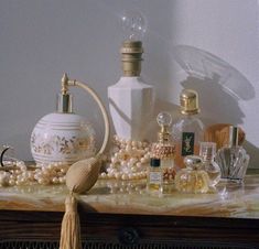 an assortment of perfumes and bottles on a table