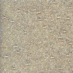 drops of water on the surface of a concrete slab, with light brown and dark gray colors