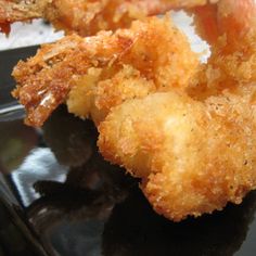 some fried food is on a black plate