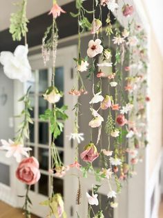 flowers are hanging from the side of a wall