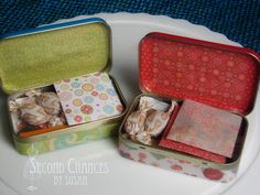 two tins filled with different types of wrapping paper on top of a white plate