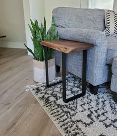 a living room with a couch, table and potted plants on the rugs