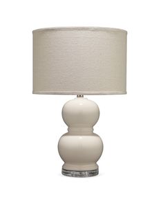 a white table lamp with a beige shade