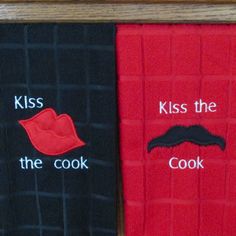 two pairs of socks with mustaches and kiss the cook written on them in white letters