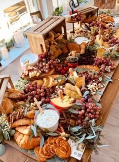 a long table filled with lots of different types of breads and other food items