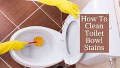 a person in yellow gloves cleaning a toilet bowl