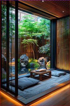 a room that has some plants and rocks in it with lights on the floor below