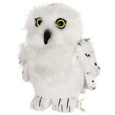 a white stuffed owl with yellow eyes