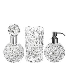 three pieces of glass bathroom accessories on a white background