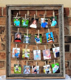 a wooden frame with pictures hanging on clothes pins