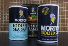 two cans of morton sea salt sitting on a counter