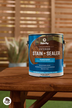 a can of exterior stain and sealer sitting on a picnic table