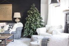 a living room filled with furniture and a christmas tree